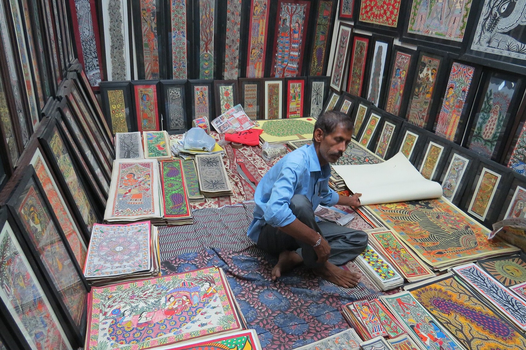 A vivid Madhubani (Mithila) folk painting filled with fish, birds and nature motifs