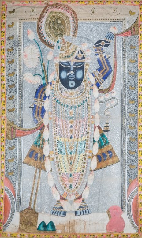 A Pichwai painting of Shrinathji in ornate jewel tones, a tradition from Nathdwara, Rajasthan